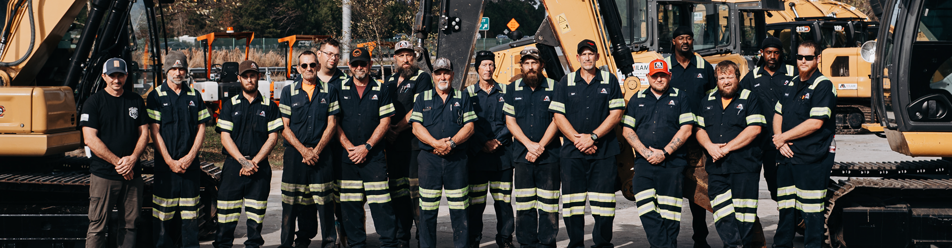 Milam Equipment Rentals team standing in front of heavy equipment