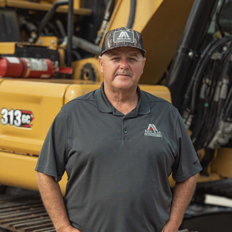 Eddie Milam in front of CAT 313 excavator
